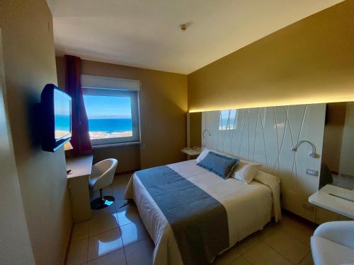 a hotel room with a bed and a window at Barion Hotel & Congressi in Bari