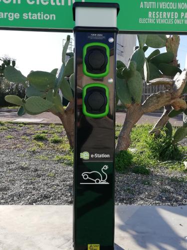 a green traffic light sitting on the side of a sidewalk at Barion Hotel & Congressi in Bari