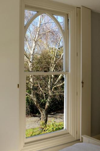 an open window with a view of a tree at The Saddlery in Greytown