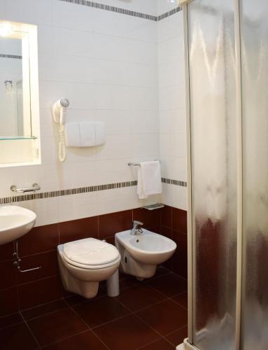 a bathroom with a toilet and a sink at Barion Hotel & Congressi in Bari
