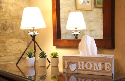 two lamps on top of a glass table with plants at Agrovino Lofou in Lofou