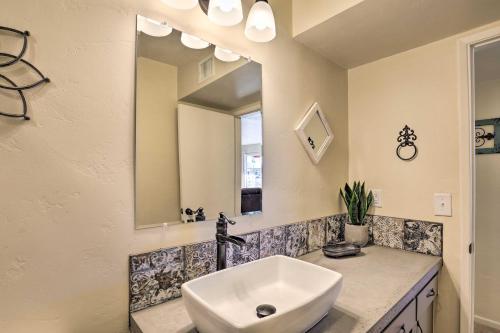 a bathroom with a sink and a mirror at Tucson Home with Patio and Games Less Than 1 Mi to Park Place in Tucson