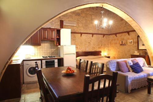 a kitchen and living room with a table and a couch at Agrovino Lofou in Lofou