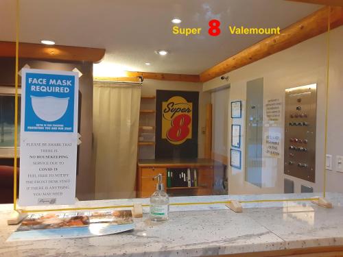 a store with a glass window with a bottle on a counter at Super 8 by Wyndham Valemount in Valemount