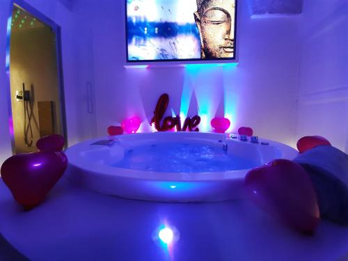 a bathroom with a tub with a tv above it at Christian's Suites & Spa in Fasano