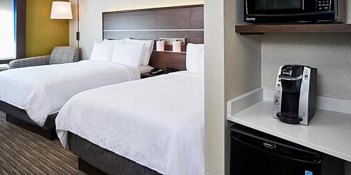 a hotel room with two beds and a television at Holiday Inn Express - Canton by IHG in Canton