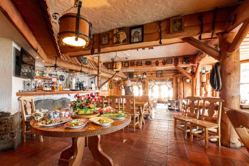 a dining room with a table with food on it at Willa Monte Rosa in Zakopane