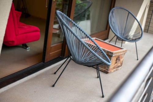 two blue chairs and a wooden box in a room at LOFT nelle Valli in Pessinetto