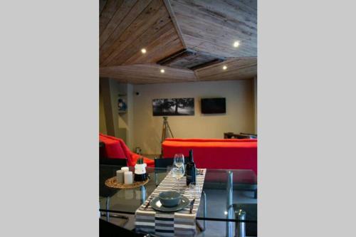 a living room with a red couch and a table at LOFT nelle Valli in Pessinetto