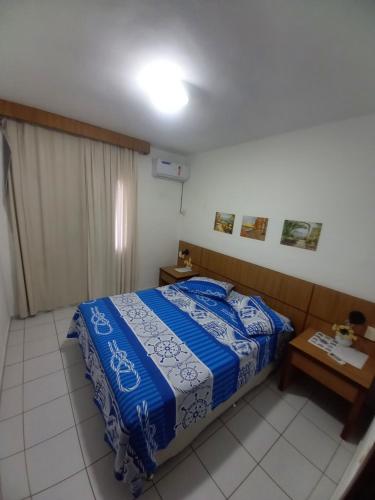 מיטה או מיטות בחדר ב-Condomínio Vila do Mar Suites