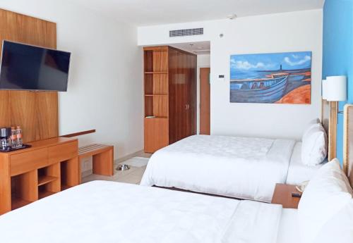 Ένα ή περισσότερα κρεβάτια σε δωμάτιο στο Holiday Inn Huatulco by IHG