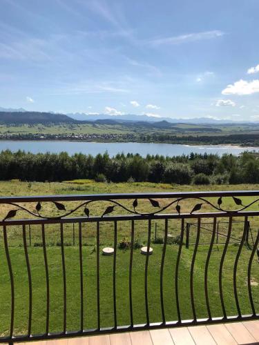 a view of a lake from a balcony at Domek na Hubce 1 in Maniowy