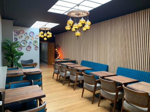 a dining room with wooden tables and chairs at Hotel Guzy in Lier