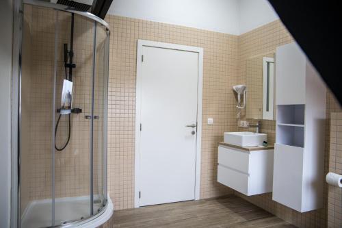 a bathroom with a shower and a sink at Hotel Guzy in Lier