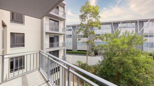 an image of an apartment building with a balcony at Oaks Sydney North Ryde Suites in Sydney