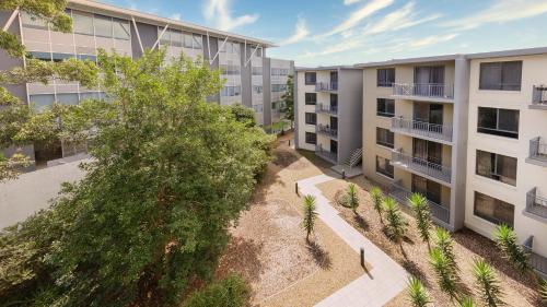 an aerial view of an apartment complex with trees at Oaks Sydney North Ryde Suites in Sydney