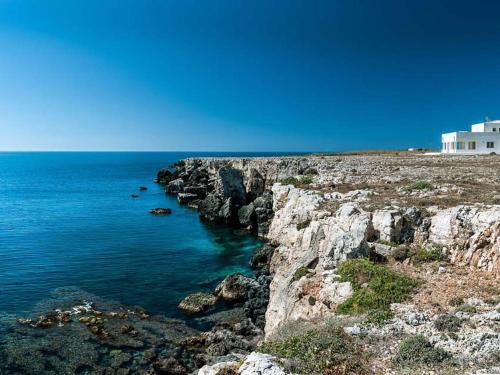 a view of a rocky shore with the ocean at Belvilla by OYO Capo Passero Dieci in Portopalo