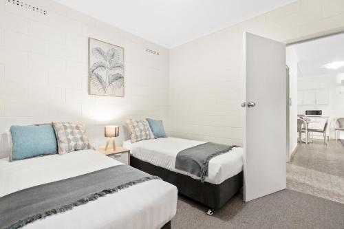 a hotel room with two beds and a table at Riversands Rest Accommodation Paringa - Willow Cottage in Renmark