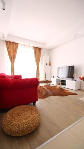 a living room with a red couch and a table at Casa Bella in Ştefăneştii de Jos