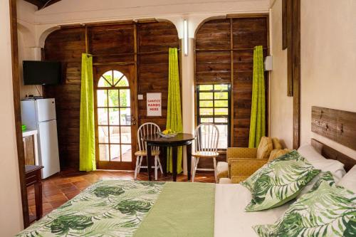 a bedroom with a bed and a living room at Sunny Palm Villas in Laborie