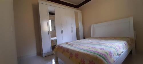 a small bedroom with a bed and a closet at prx à praia com piscina in Mongaguá