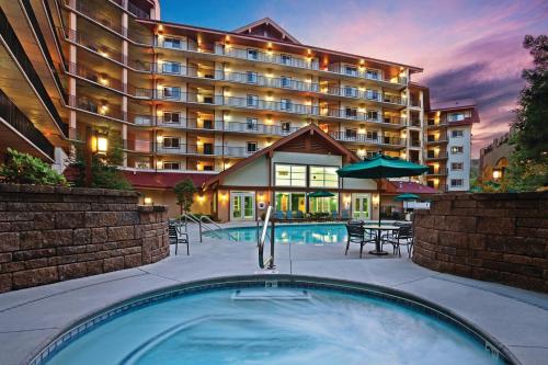 a hotel with a swimming pool in front of a building at Holiday Inn Club Vacations Smoky Mountain Resort in Gatlinburg