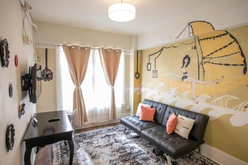 a living room with a couch and a painting on the wall at Hotel Des Arts in San Francisco