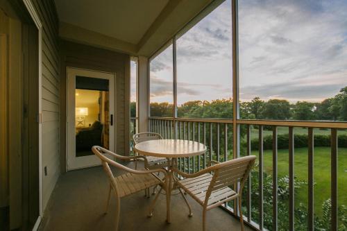 a porch with a table and chairs on a balcony at Holiday Inn Club Vacations South Beach Resort in Myrtle Beach