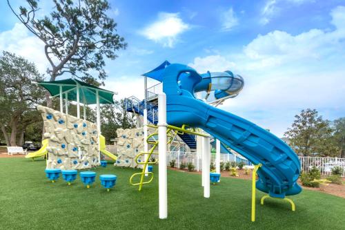 a playground with a blue water slide at Holiday Inn Club Vacations South Beach Resort in Myrtle Beach