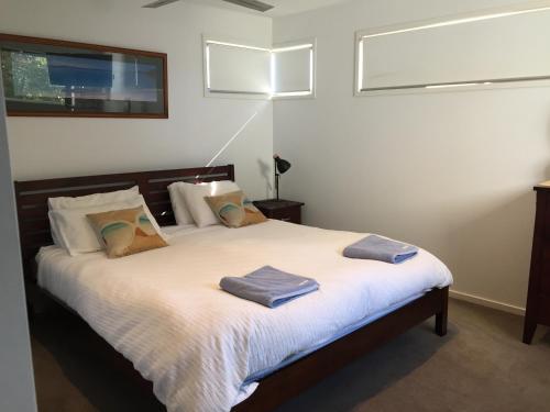 a bedroom with a bed with two towels on it at Woolamai Beach Haven, Easter special, reduced price, wine & chocs in Cape Woolamai