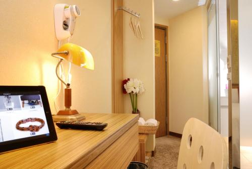 a room with a desk with a computer on it at Golden Hotel in Taipei