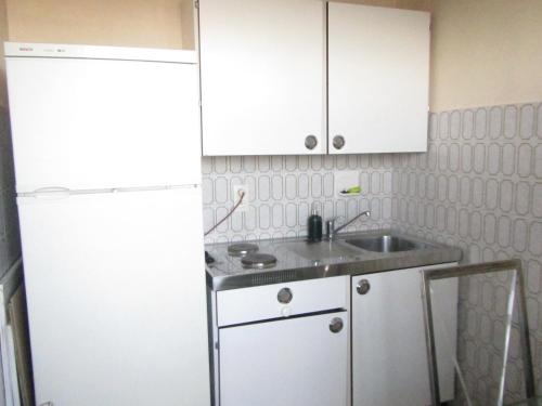 a kitchen with a sink and a white refrigerator at - - - - - Au Sixième Ciel - - - - - in Brussels