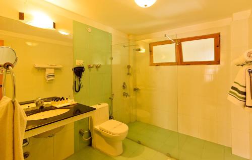 a bathroom with a toilet and a sink and a shower at Ladakh Residency in Leh