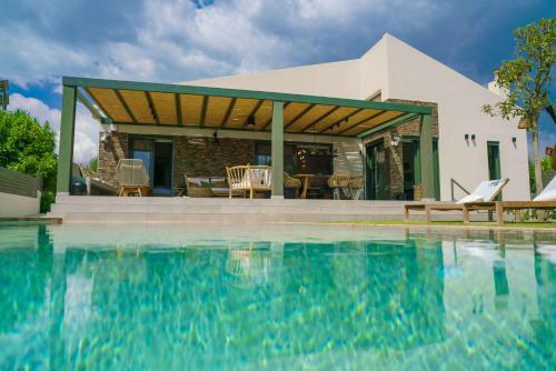una casa con piscina di fronte a una casa di Luxury Country House a Mavrommátion