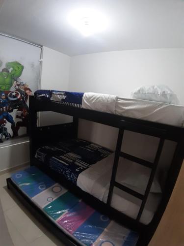 Ένα ή περισσότερα κρεβάτια σε δωμάτιο στο Aparta-Hotel Cafetero Oviedo