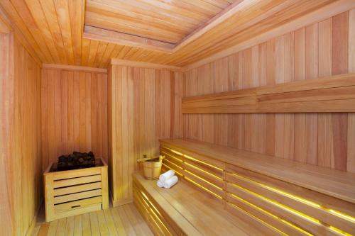 a sauna with wood paneling and a wooden ceiling at Somerset Sudirman Jakarta in Jakarta