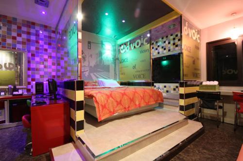 a room with a bed in the middle of it at Vov Hotel in Busan