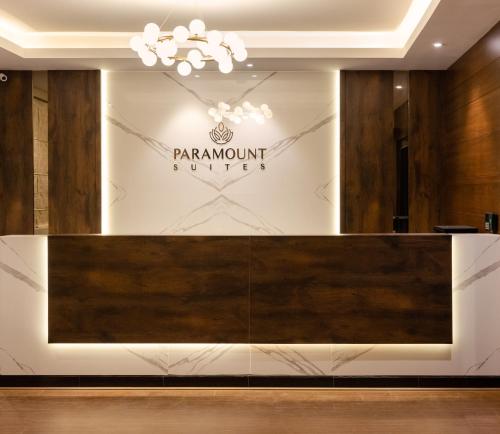 a store front with a sign on the wall at Hotel Paramount Suites & Service Apartments in Mangalore