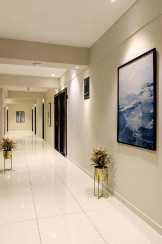 a hallway with two potted plants in a building at Hotel Paramount Suites & Service Apartments in Mangalore