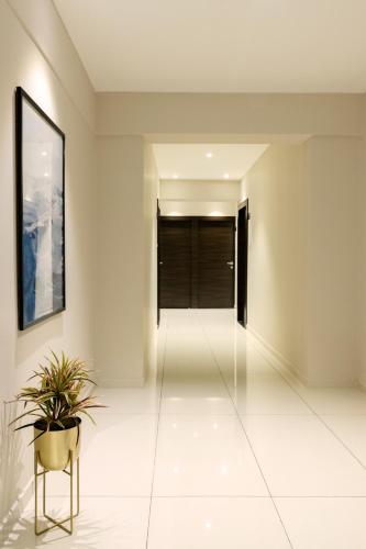 a hallway of a house with a potted plant at Hotel Paramount Suites & Service Apartments in Mangalore