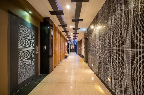 a hallway of a building with wooden floors and walls at Vov Hotel in Busan