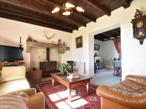 a living room with a couch and a table at Holiday home in nature near D cize in Decize