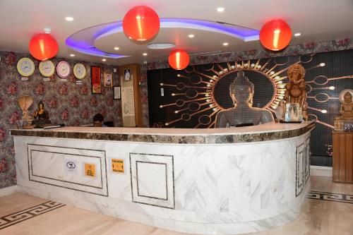 a bar in a restaurant with red lights at HOTEL ANAND INTERNATIONAL in Bodh Gaya