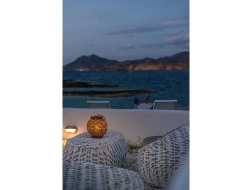 a vase sitting on top of a table next to the ocean at Venia's Guesthouse in Pollonia