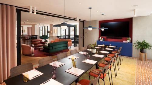 a conference room with a long table and chairs at Hotel Indigo Adelaide Markets by IHG in Adelaide