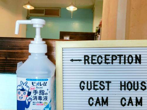a bottle of bleach next to a sign in a store at Guest House Cam Cam Okinawa in Naha