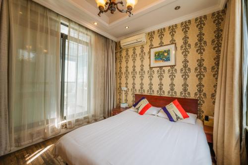 Boyi Apartment - Shanghai National Convention and Exhibition Center Branchにあるベッド