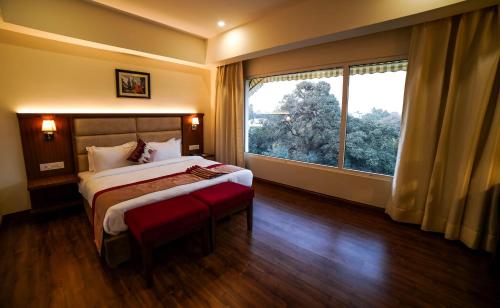 Ein Bett oder Betten in einem Zimmer der Unterkunft Hotel Le Amritam