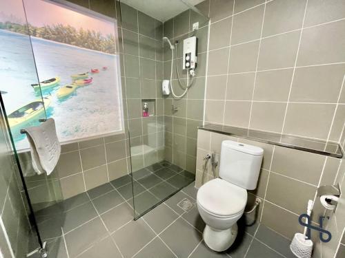 a bathroom with a toilet and a shower at Homesuite' Home at Aeropod SOVO in Kota Kinabalu