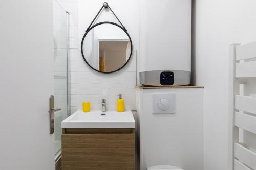W łazience znajduje się umywalka i lustro. w obiekcie DIFY City - Charpennes w mieście Villeurbanne